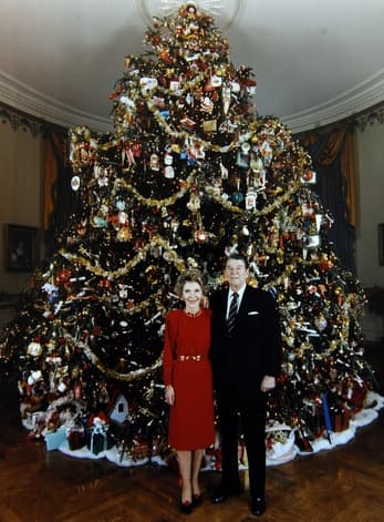 1981 ornaments loaned by Museum of American Folk Art for First Lady Nancy Reagan: President and Mrs. Ronald Reagan in front of the 1981 White House Christmas tree.
