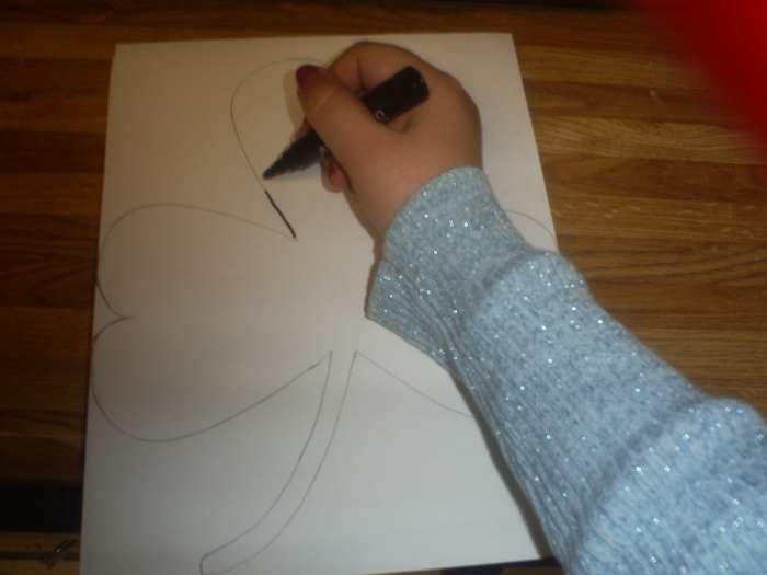 Trace the shamrock with a black marker.