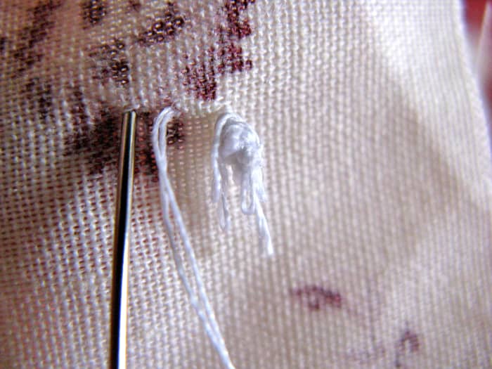 Continue making your stitches evenly, entering the fabric on the same side your thread is coming out of.