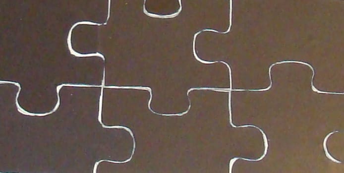 Trimming at an angle reveals a bit of the wood, and ensures that the magnetic backing will not interfere with putting the puzzle together.