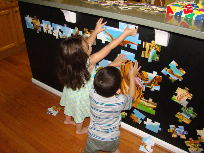 My two year old enjoys making straight lines with the pieces, while my four year old works on discovering the picture.