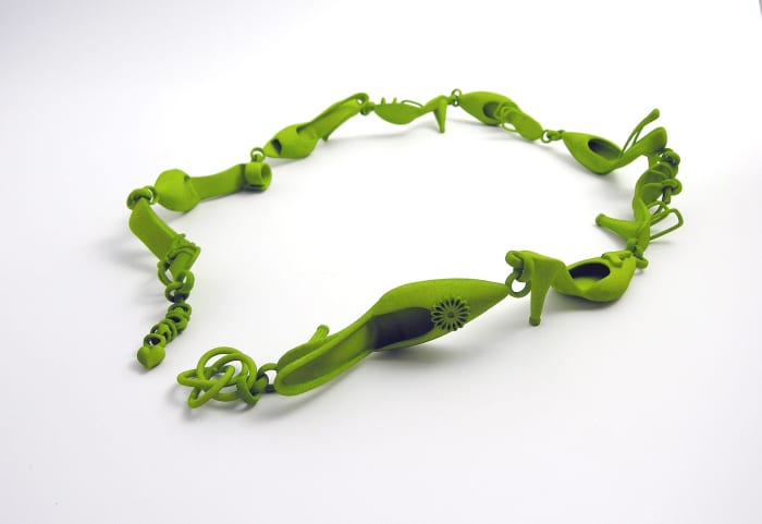 This 3D printed bracelet is composed of shoes and created by a jewelry designer. It may have been created by a more advanced printer than a consumer-oriented one.