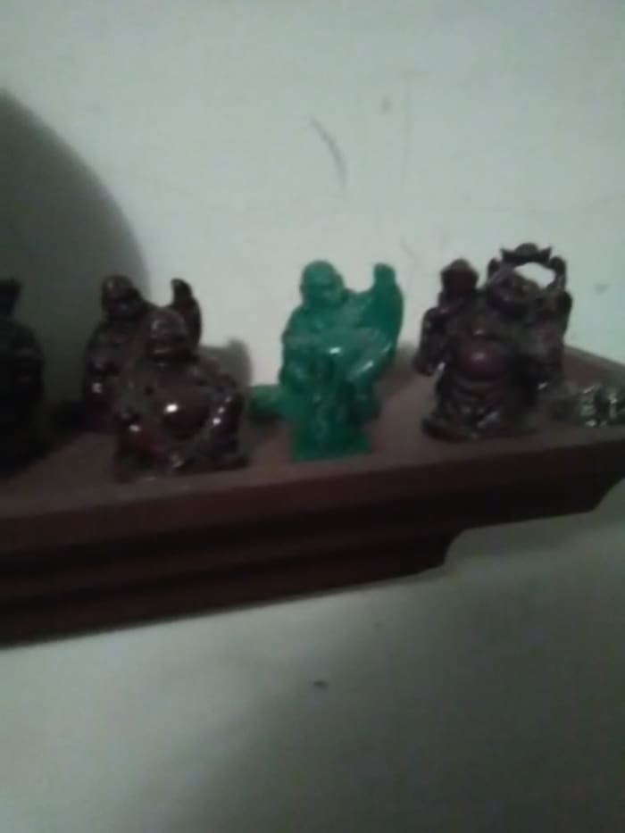 3D printed model is the small green plastic statue in front of the jade (green) laughing Buddha. In Cura, 3D objects can be scaled for different sizes and slightly different shapes.