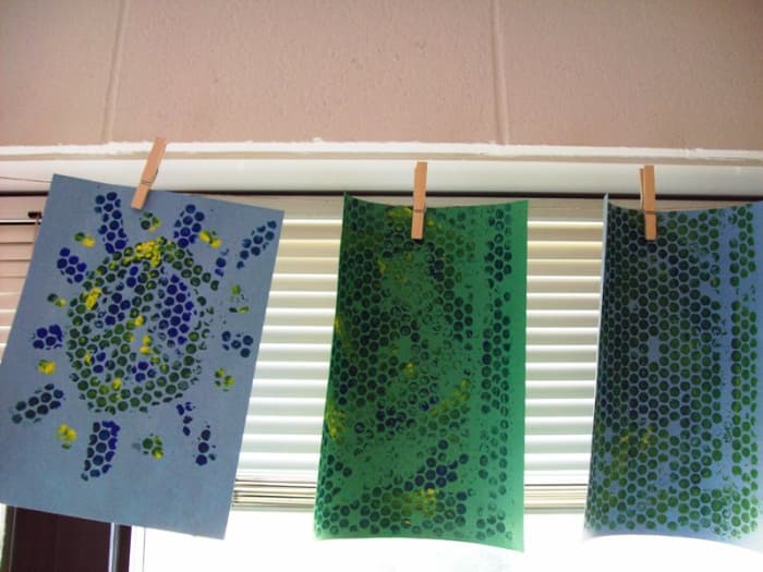 Hanging artwork from a cord or wire is a great do-it-yourself project. Use clothespins to secure in place.