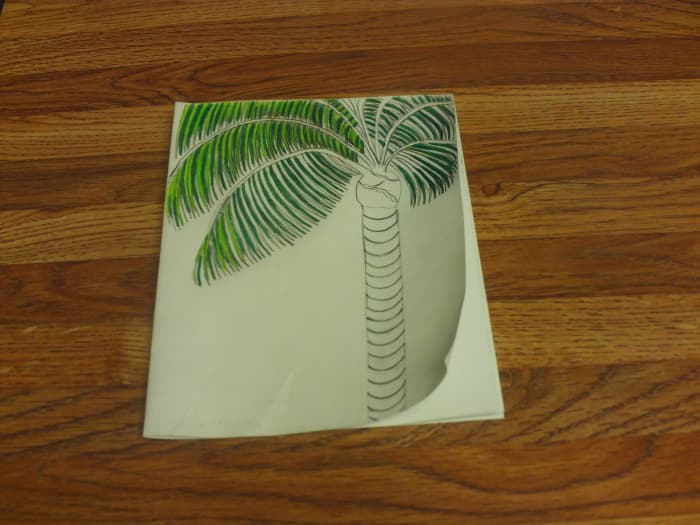 Coloring in the lighter portions of the palm fronds.