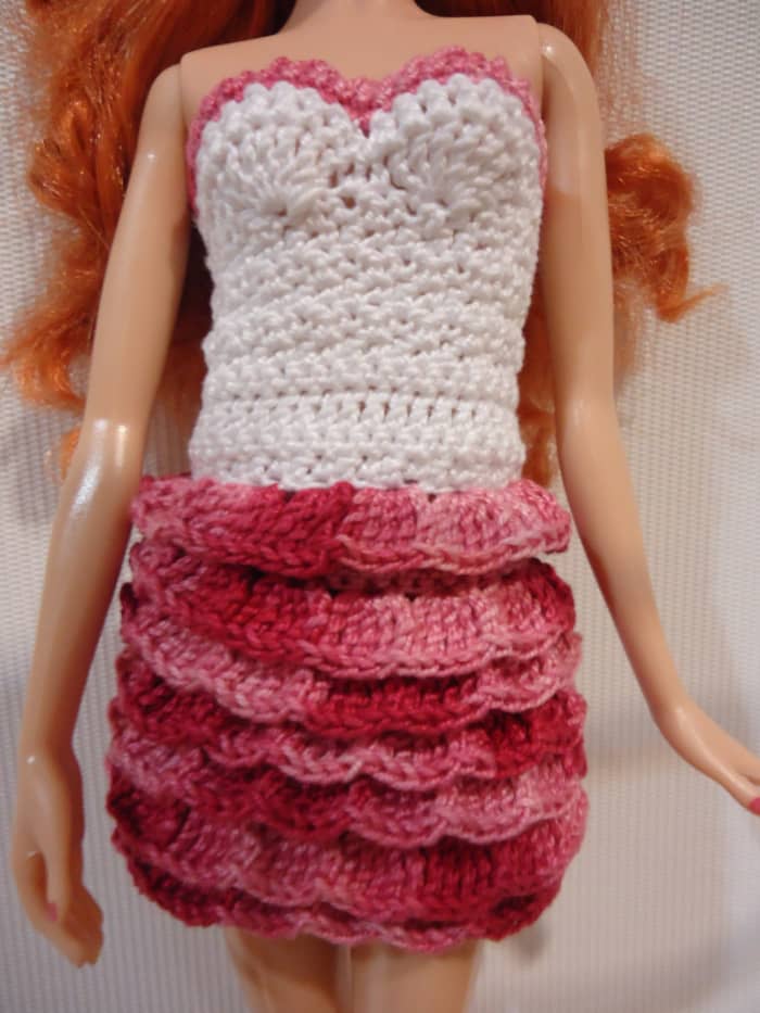 For this ruffle, there are 5 tr in 1 st, sk 2 stitches, then 5 tr again in the next st. The effect is like fish scales, having clusters of 5 tr in every other stitch for the row.