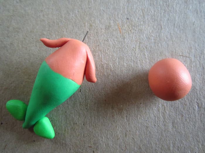 I attached the arms then put a small piece of wire on through the neck to make sure the head would stay on.