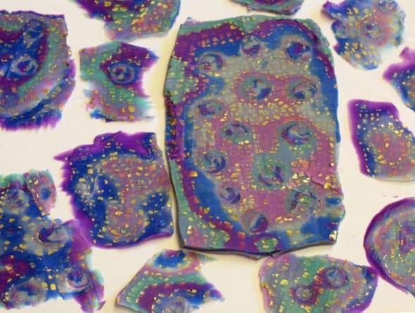 Shaved polymer clay mokume gane stack. Each slice has fewer colors spaced more widely apart because the layers in the mokume stack were too thick.