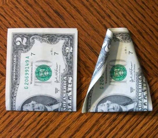 Step 1: Fold the bills in half first as it will make curling the edges easier.