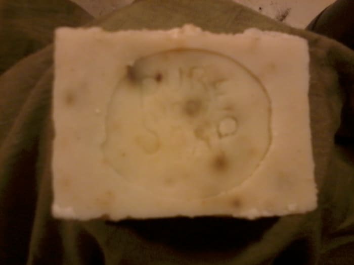 My standard soap recipe usually produces a white bar. This time I colored it gently with lemon balm.