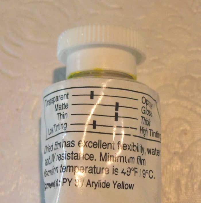 On many acrylic paint tubes there is a graphic display of the color characteristics. It shows four scales from transparent to opaque, from matte to gloss, from thin to thick, and from low tinting to high tinting.
