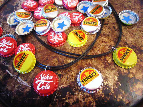 Create simple button cap necklaces with genuine metal caps by punching a hole in the top, attaching a jump ring, and stringing a cord or chain through it.