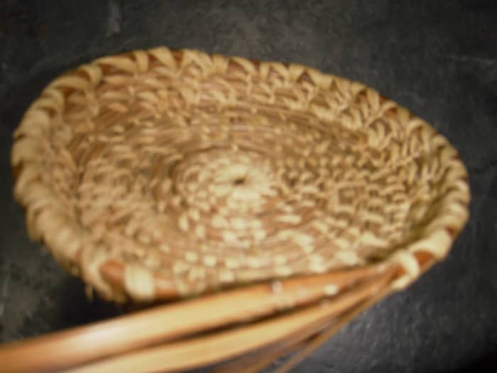 Once the base of the pine needle basket is the right size, start to turn the coil up to form the basket sides.