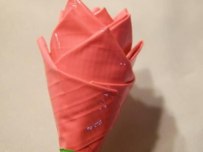 Step 7: Keep on adding petals until you like the look of your rose. You can place the petals going down to make it a rose just blooming.