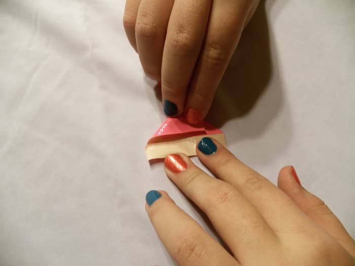 Step 3: Fold left corner down until the side meets the first fold.