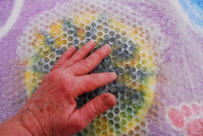 Rub firmly with fingers creating friction on fibers. Concentrate on the center to begin with. Then start rubbing the whole flower.