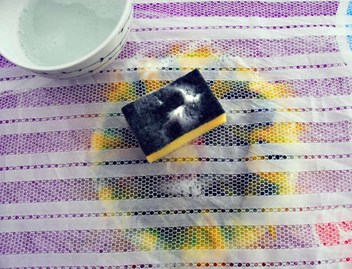 Add more hot soapy water with the sponge until completely damp throughout the layers. Try not to add so much that you displace the fibers at the same time.