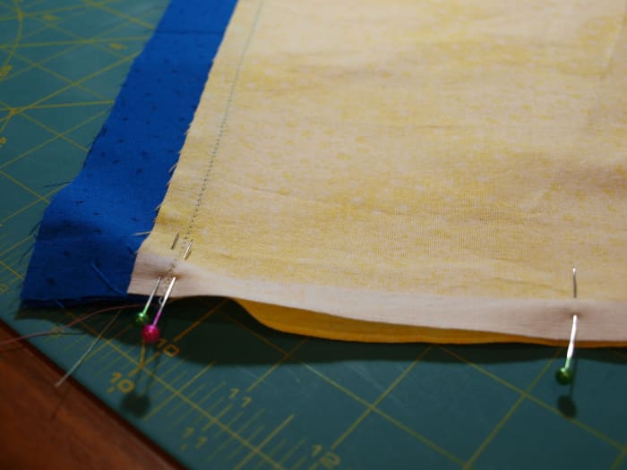 1. Fold the short sides of the border strip together (right sides facing each other) and pin. It will form a loop.