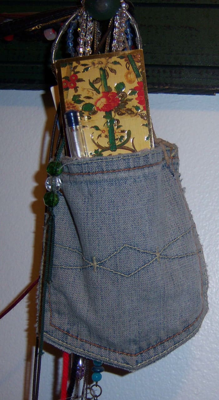This is just the pocket from an old pair of my jeans. I punched holes in the corners and tied a length of suede through them.