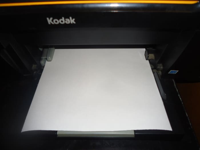 Place fabric sheet in your printer. I place mine in the feeding tray with the fabric side down. Each printer is different so make sure you are placing your fabric sheet properly so it will print on the fabric side.