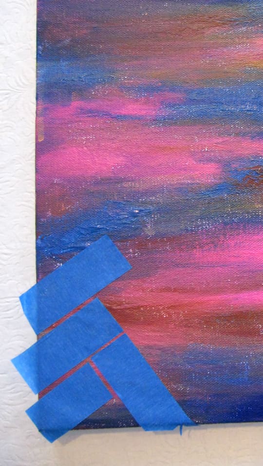 Start from a corner and apply the strips of masking tape leaving a consistent gap between each one.
