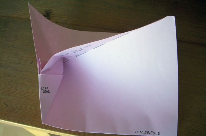 I. You'll get a nice shape once the corner is tucked into the pocket. This curve is what you'll squash in the next step.