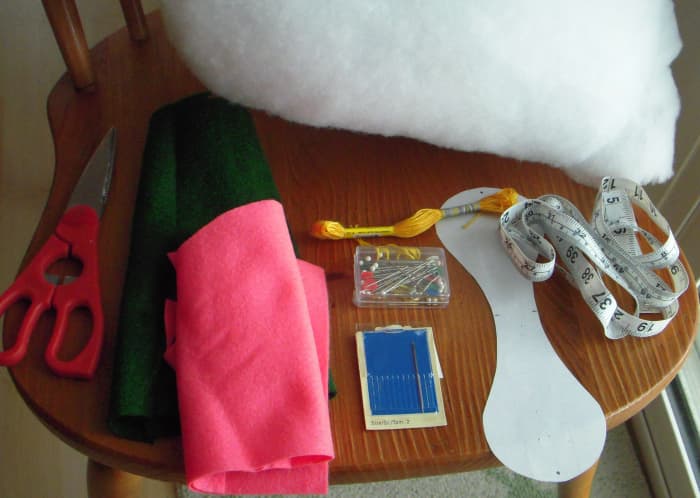 Materials to make a cloth ball include: nonwoven fabric, polyfluff, pins, needle, embroidery thread, tapemeasure, paper to draft a pattern, and scissors.
