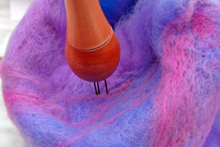 Needle felt the fibers to the existing Bird Pod. The idea is to build up the fibers wherever you find any thin spots.