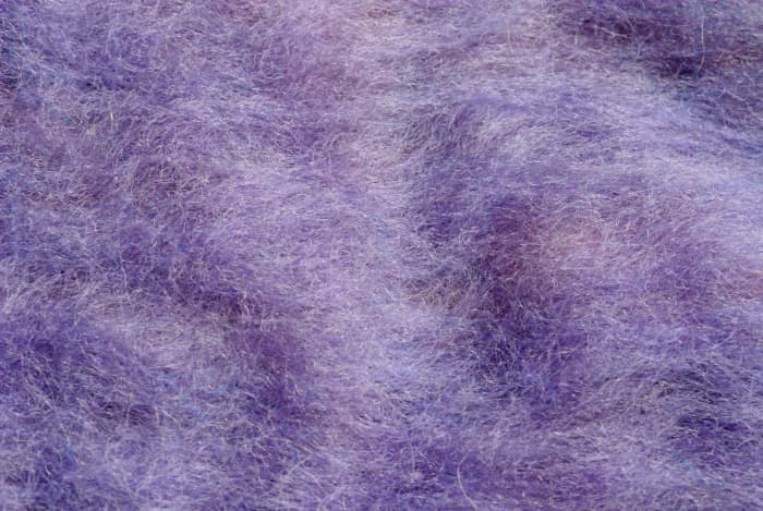 Incomplete fulling (wrong side): The underneath side of the blue felt above shows that the project too was insufficiently fulled. The fibers are still floating.