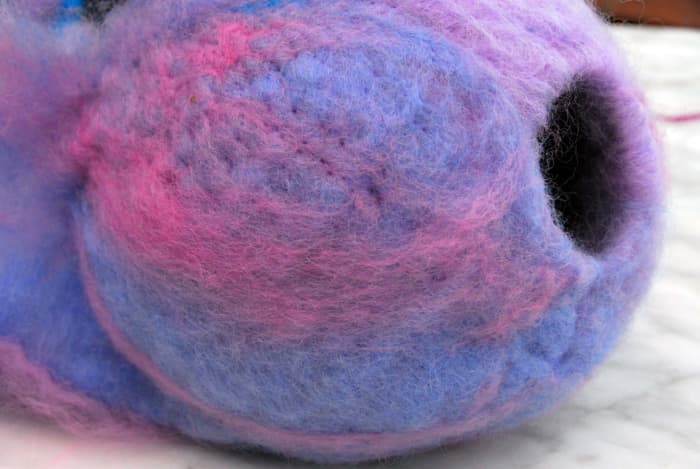 The thin spots which were once visible have now been filled in the front of the Bird Pod using the needle felting tool