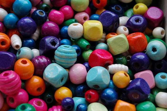 Wooden beads can be bought in a wide range of colours, shapes and sizes. They can also be made using several methods easily and cheaply at home.