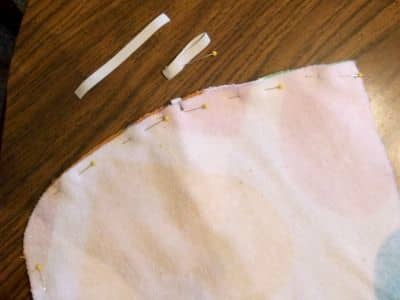 Cut a 4" piece of 3/8" wide elastic, fold it in half, and insert it with the loop side to the inside.