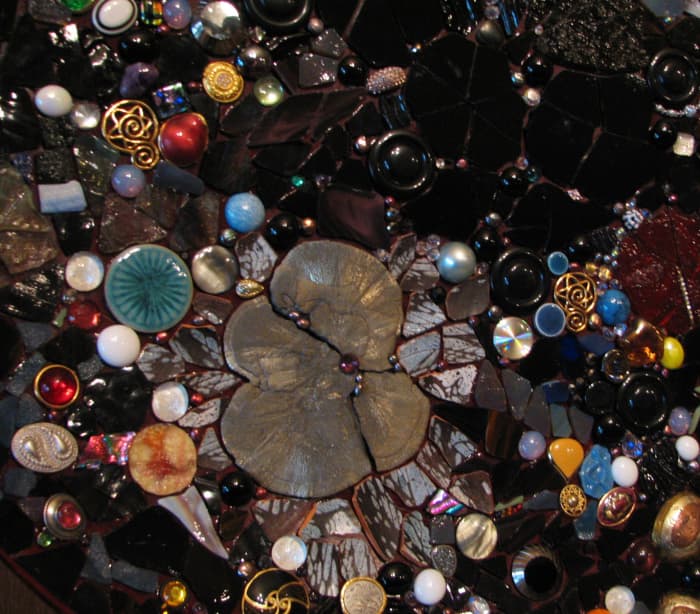 Outer space mosaic, contains an iron pyrite flower, glass globs, stained glass, glass cabochons, broken pottery, ceramic tile, costume jewelry, crystals, amethyst, pearls
