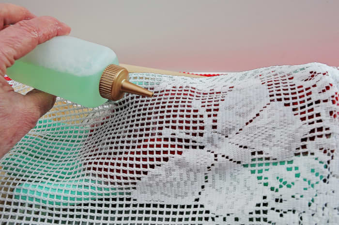 Cover with curtain netting and then wet and smooth down until the fibers are wet through but not saturated with excess water.