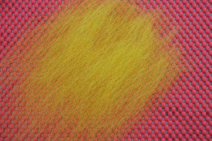 Use a thin layer of wool roving. Lay fibres down first in one direction and the next layer at 90 degrees to the first layer.