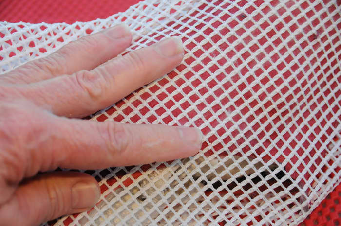 Use a piece of curtain netting to cover the wet fibers and rub gently to flatten down to smooth out the fibers.