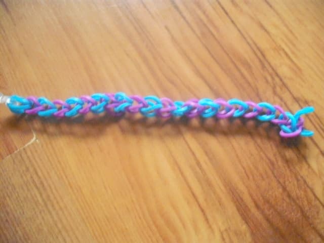 Keeping making '8' shapes with the bands in alternative colours until you reach the length you need to fit the person's wrist.