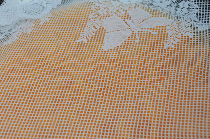 Cover with curtain netting and wet with hot soapy water. Smooth and remove netting, turn over.
