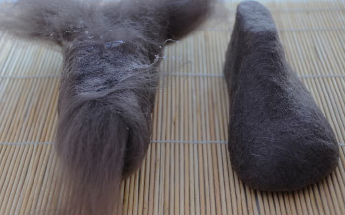 Encase both the shoe lasts in four layers of wool fibers, use the curtain netting to help support the fibers by pulling the netting up tight against the last. Wet with hot soapy water before and after doing so.