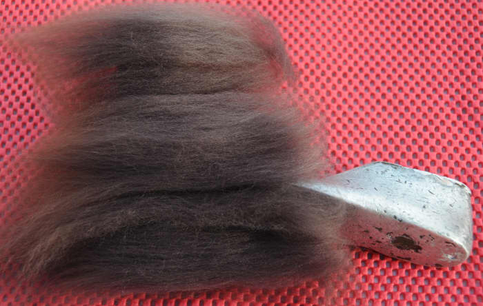 Lay the fibers on the underside of one shoe last. The second shoe last is seen supporting the first shoe last.