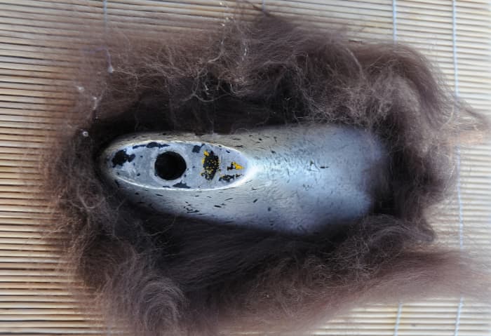 4. The underside of the shoe has fibers attached and smoothed down with hot soapy water. The top fibers should now be folded in to complete the whole foot.