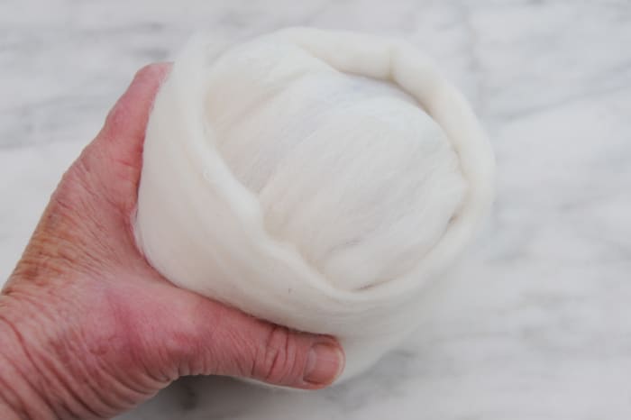 Cover in White Roving until the ball is evenly covered, smooth out the layers carefully.