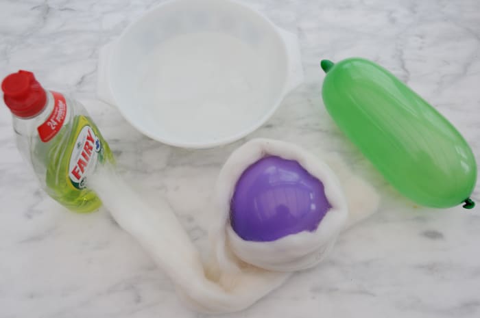 A sausage shaped balloon, 1 small round balloon approximately 11 cm each in length, Merino Wool Roving and a small bowl.