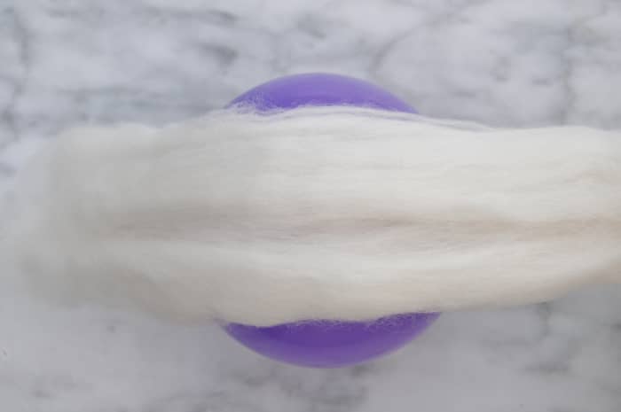 Spread out the roving and wrap the balloon in a piece which goes around with a small overlap.