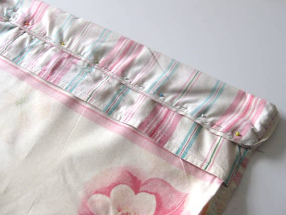 Make sure you pin the hem around the whole pillowcase opening, not just on one side. On one side, you'll have the folded pocket bit that is usually on a pillowcase, and on the other side will be a plain hem with one layer of fabric.