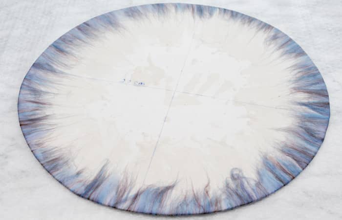 Turn the template over and fold the wool fibers over with a little hot soapy water.