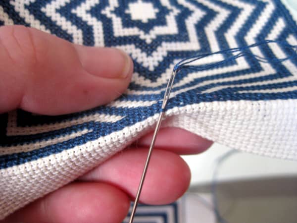 Work from top to bottom and sew the needle through the centre backstitch of the middle of Side 1.