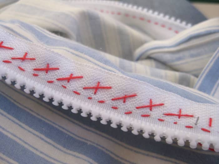 What the cross stitch looks like on the back - see how it holds the zip edges in place?