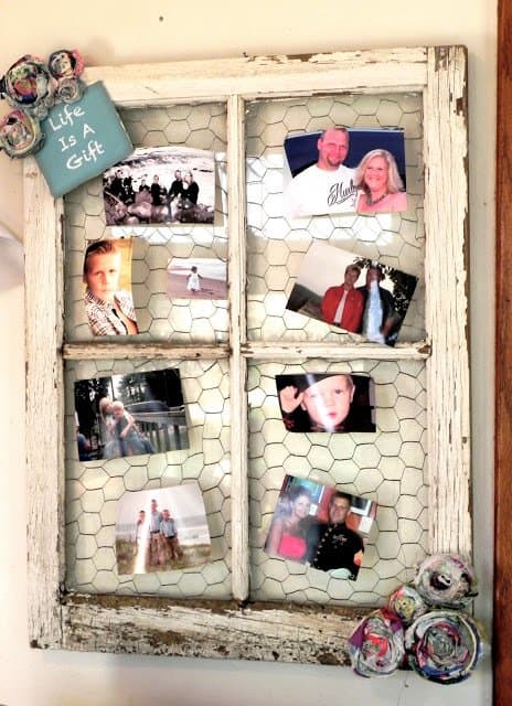 Laura backed her frame with chicken wire and added some fabric rosettes and a little "Life is a gift" sign.