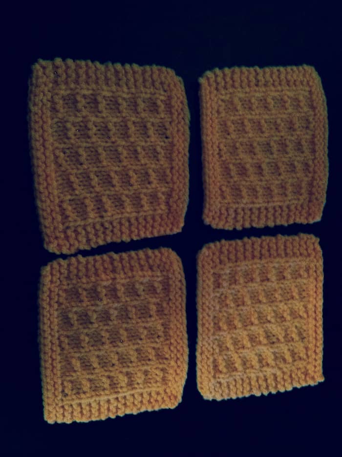 This is an example of a set of four coasters made with this free knitting pattern and ready to be put to use!